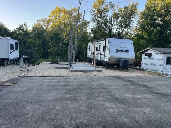 a wooden bench sitting in front of a house