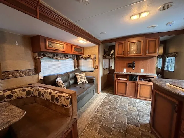 a bed sitting in a bedroom next to a larger window