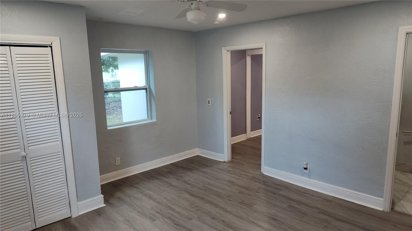 849 West 2nd Street, Unit B Riviera Beach, FL 33404 - Photo 3 of 10 an empty room with wooden floor and windows