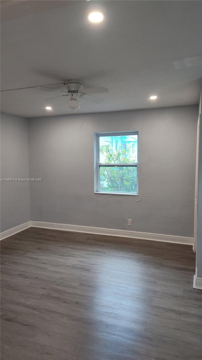 849 West 2nd Street, Unit B Riviera Beach, FL 33404 - Photo 6 of 10 an empty room with wooden floor and windows
