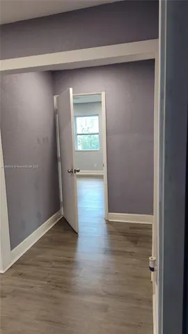 an empty room with wooden floor and closet