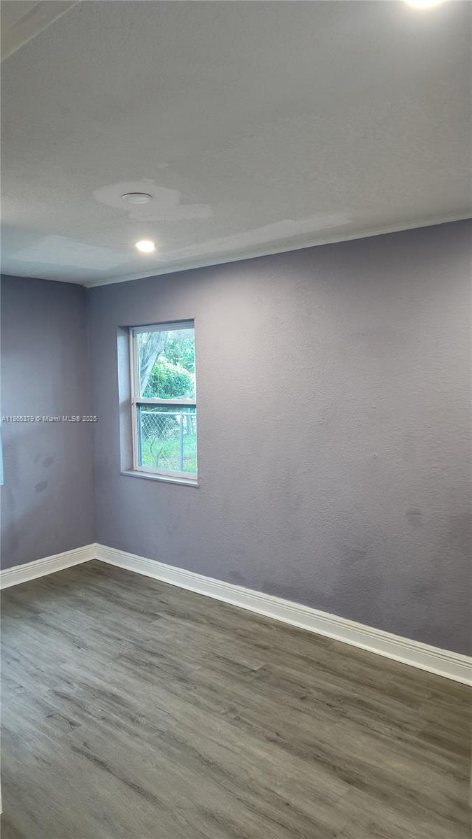 849 West 2nd Street, Unit B Riviera Beach, FL 33404 - Photo 9 of 10 a view of an empty room with wooden floor and a window