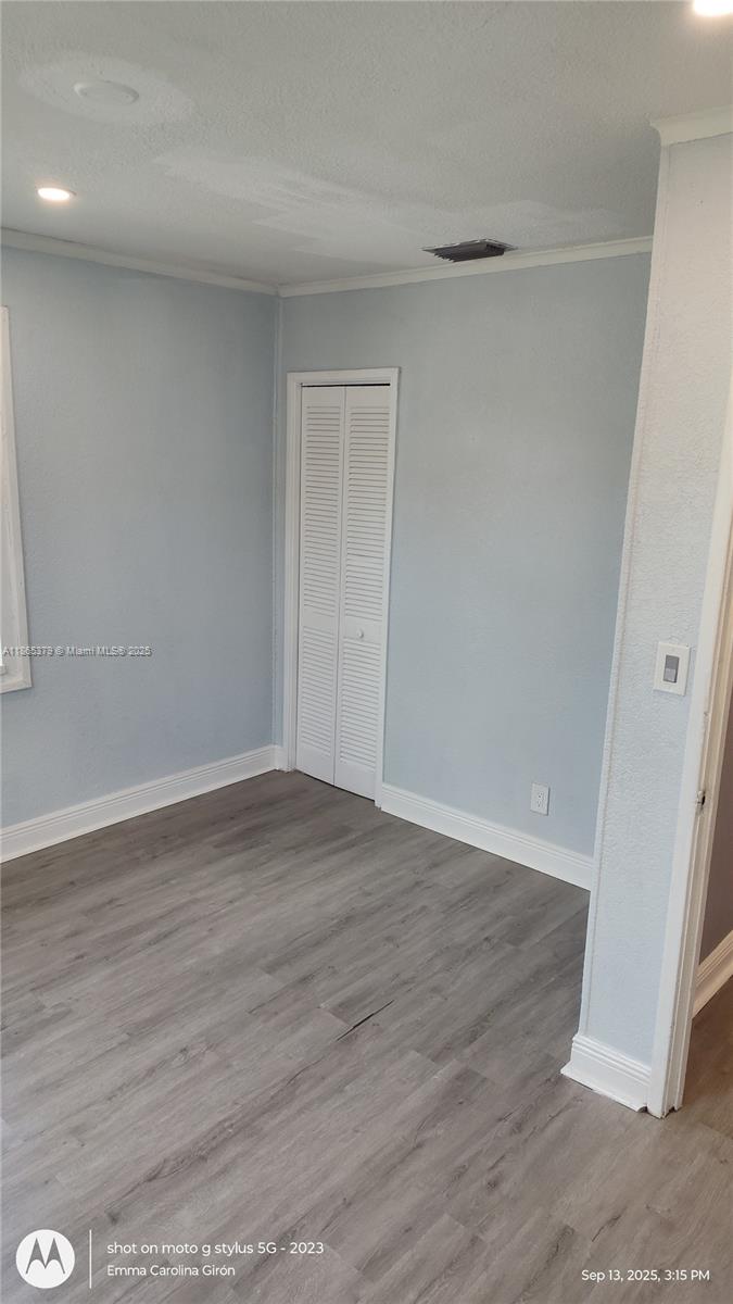 849 West 2nd Street, Unit B Riviera Beach, FL 33404 - Photo 10 of 10 a view of an empty room with wooden floor and a window