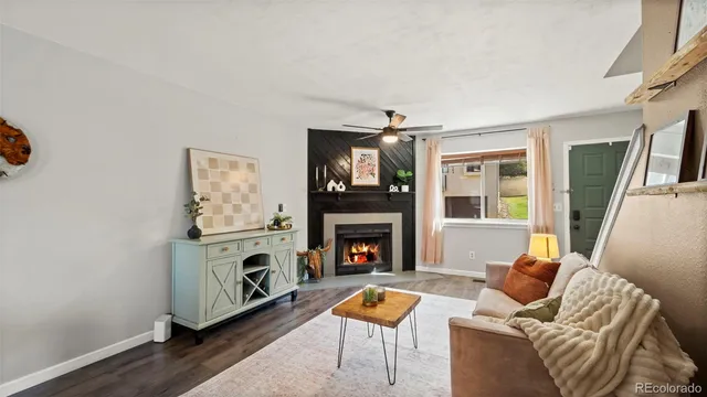 a kitchen with stainless steel appliances a stove a sink dishwasher a refrigerator white cabinets and wooden floor