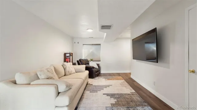 a view of hallway with a large window and wooden floor