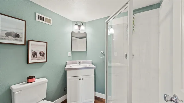 a view of a hallway with wooden floor and entryway