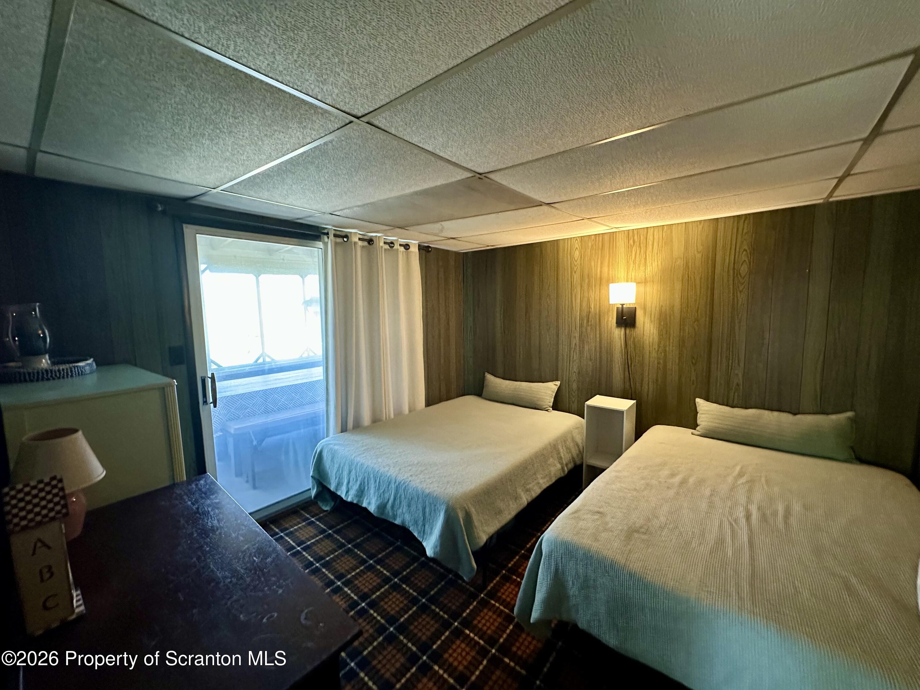 130 1st Street Tunkhannock, PA 18657 - Photo 11 of 23 a bedroom with two beds and a chair