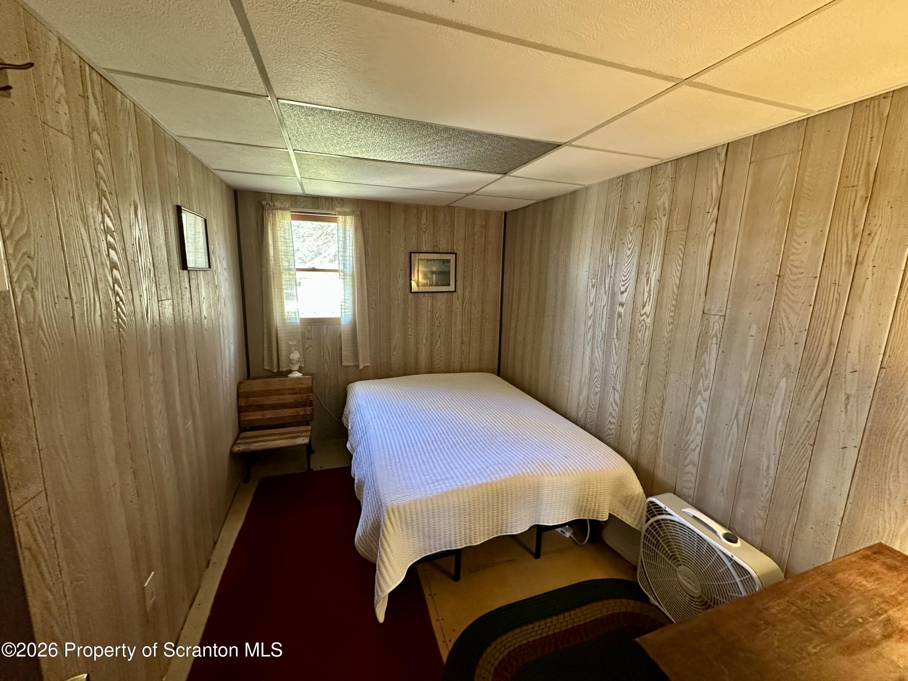 130 1st Street Tunkhannock, PA 18657 - Photo 12 of 23 a bedroom with a bed and wooden floor