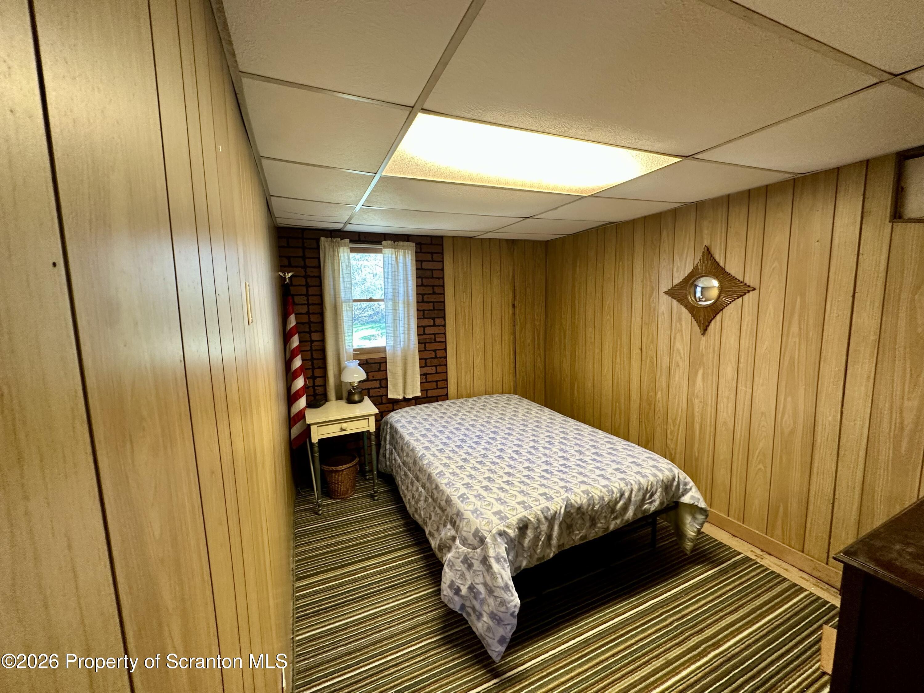 130 1st Street Tunkhannock, PA 18657 - Photo 13 of 23 a bedroom with a bed and wooden floor