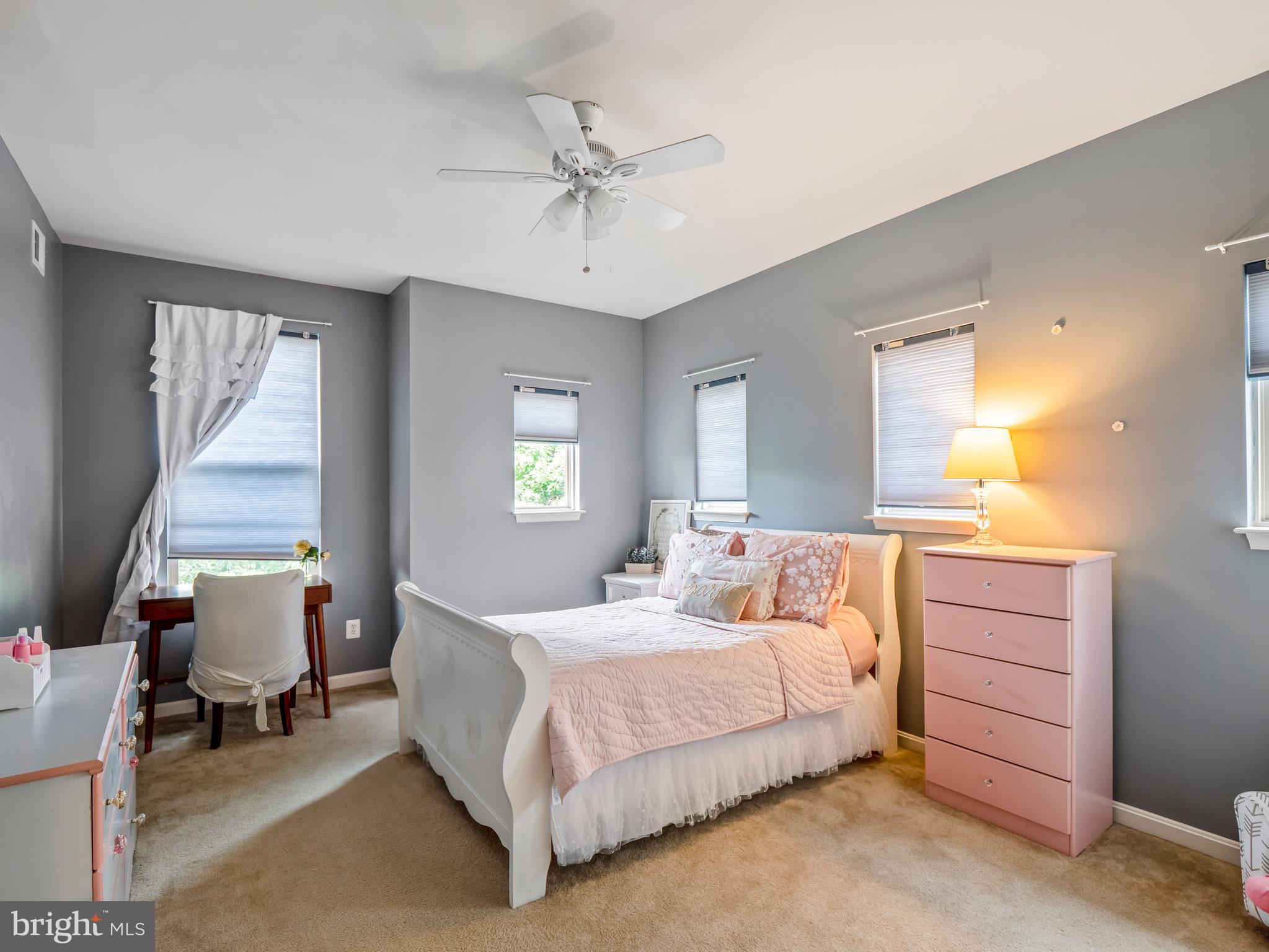 23366 Evening Primrose Square Brambleton, VA 20148 - Photo 20 of 28 a bedroom with a bed and a chandelier