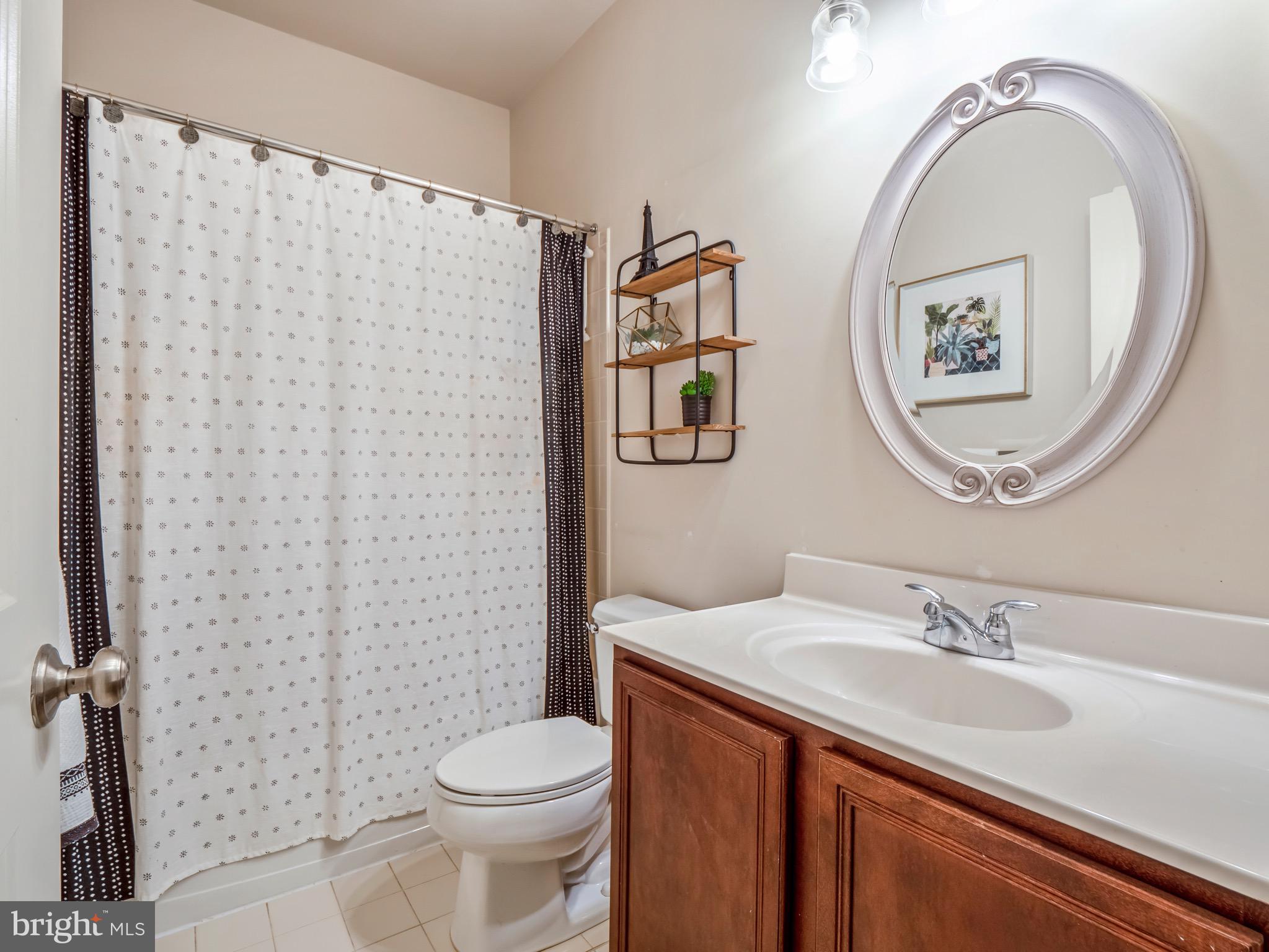 23366 Evening Primrose Square Brambleton, VA 20148 - Photo 23 of 28 a bathroom with a granite countertop sink mirror vanity and toilet