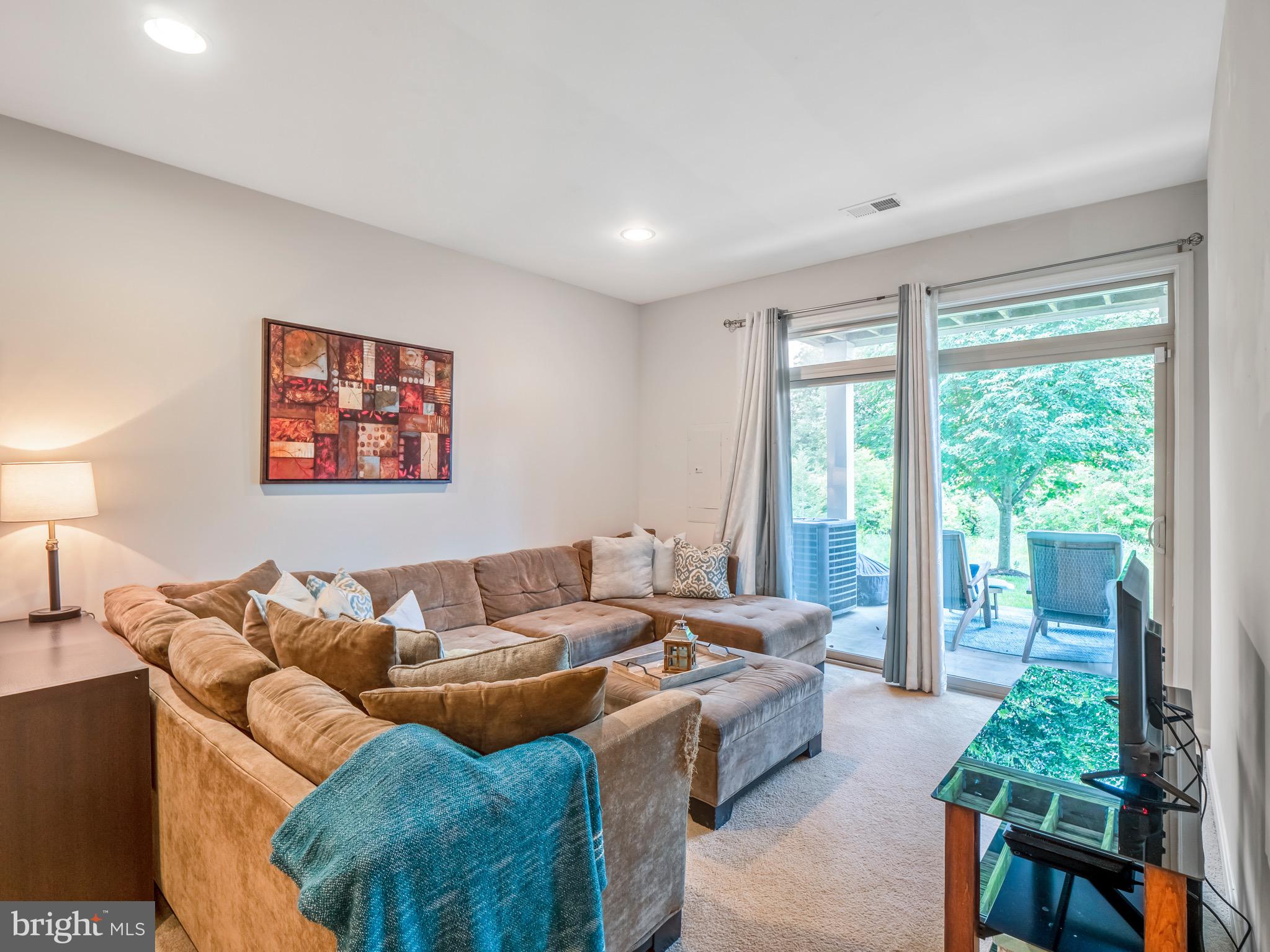 23366 Evening Primrose Square Brambleton, VA 20148 - Photo 25 of 28 a living room with furniture and a large window