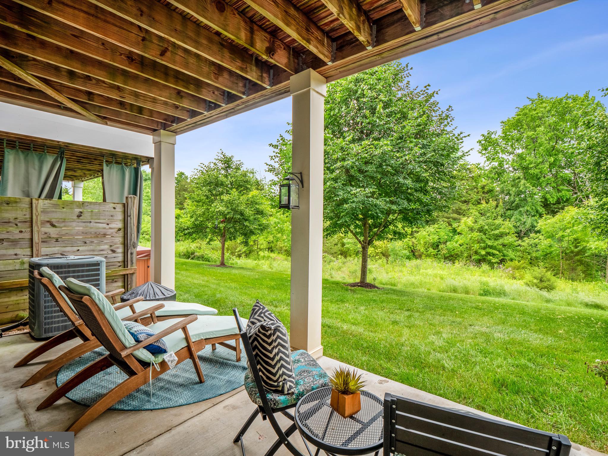 23366 Evening Primrose Square Brambleton, VA 20148 - Photo 5 of 28 a patio with yard glass top table and chairs