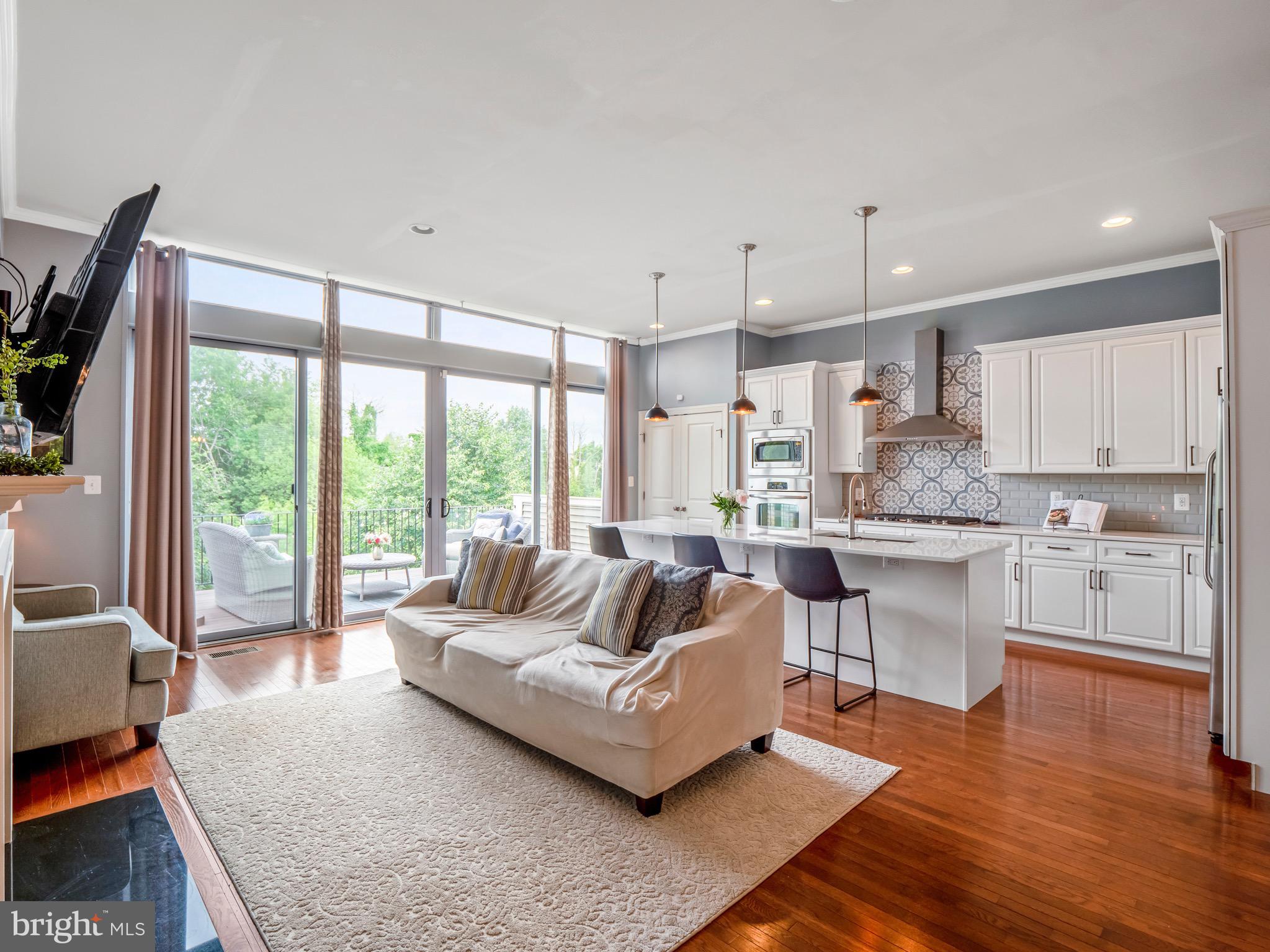 23366 Evening Primrose Square Brambleton, VA 20148 - Photo 6 of 28 a living room with kitchen island furniture and a large window