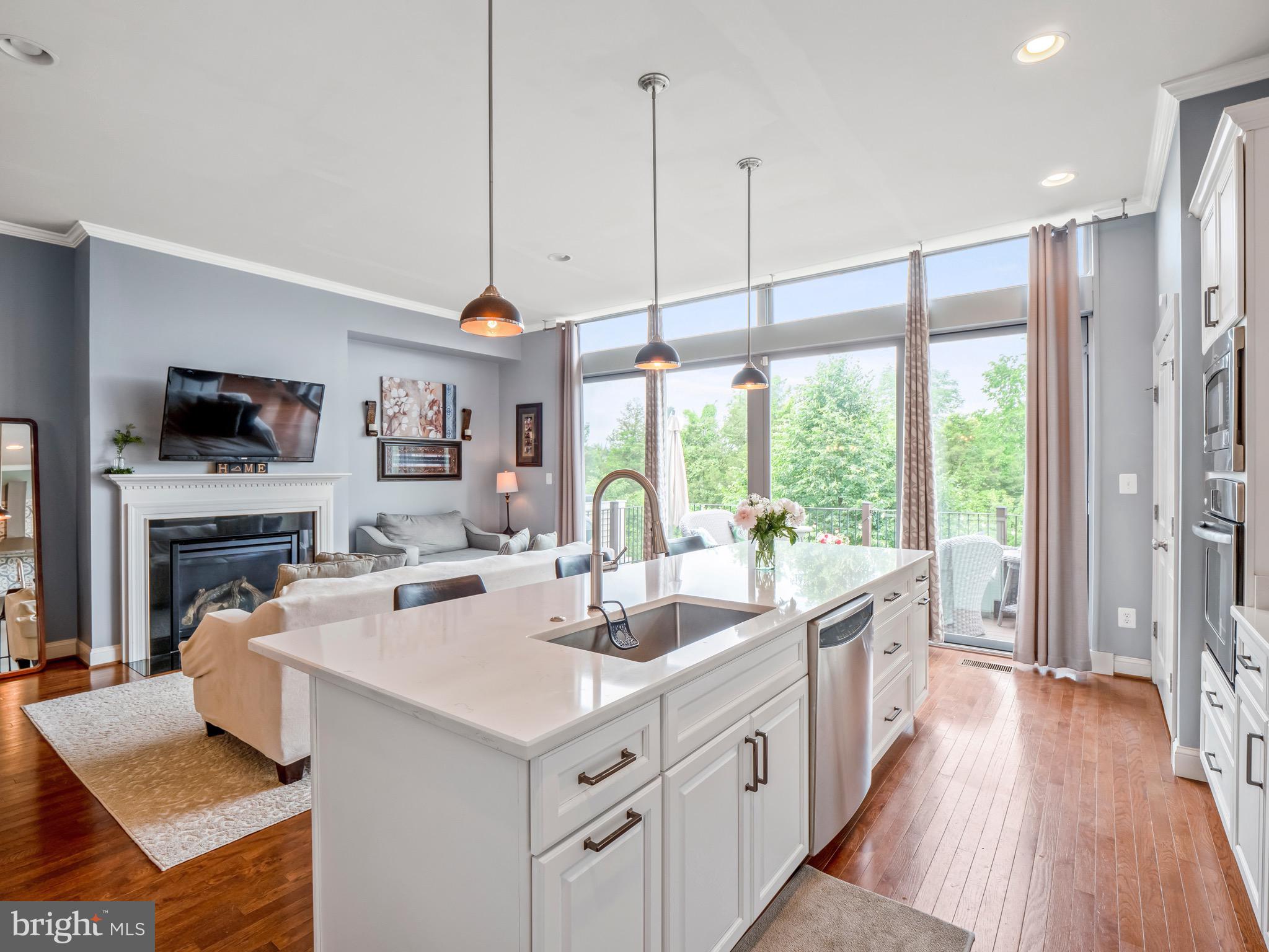 23366 Evening Primrose Square Brambleton, VA 20148 - Photo 8 of 28 a kitchen with a sink a counter top space stainless steel appliances and a large window