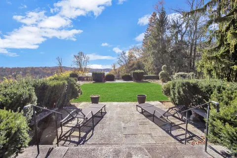 a view of a patio with table and chairs and potted plants