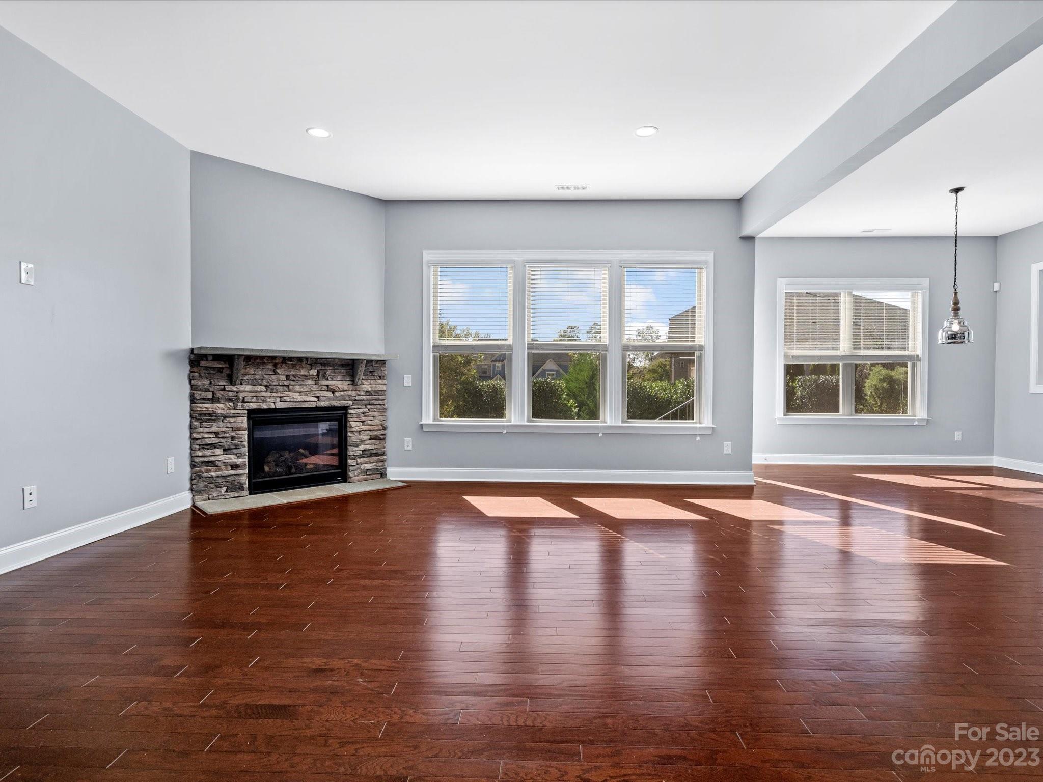 7009 Fallondale Road Waxhaw, NC 28173 - Photo 11 of 47 a view of empty room with wooden floor and fireplace