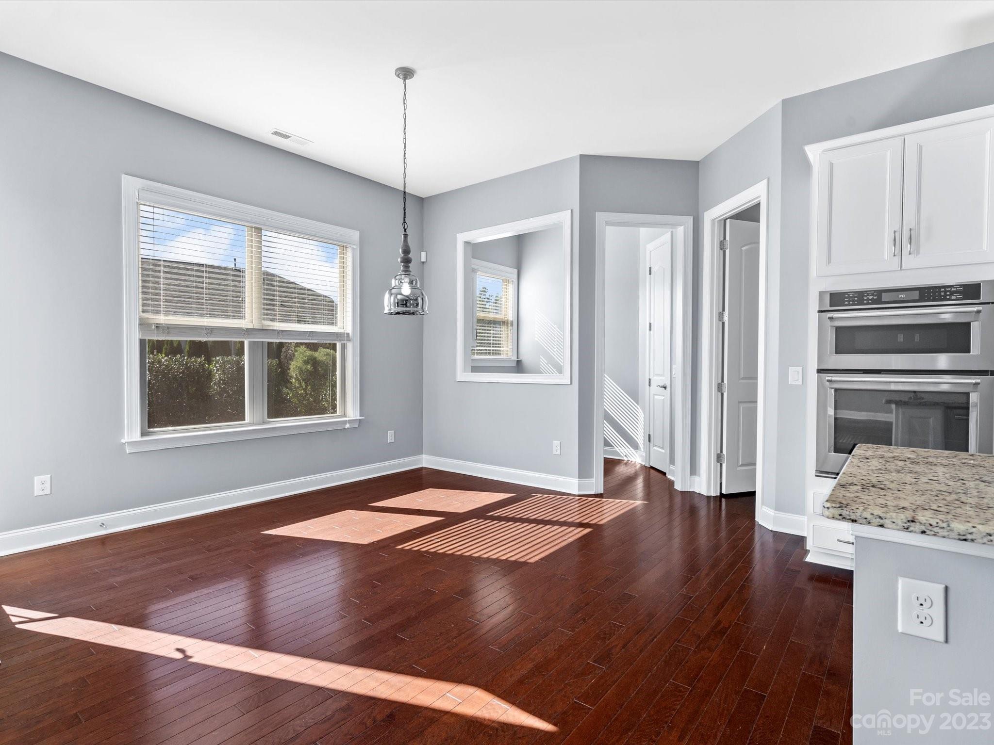 7009 Fallondale Road Waxhaw, NC 28173 - Photo 13 of 47 a view of an empty room with a window and wooden floor