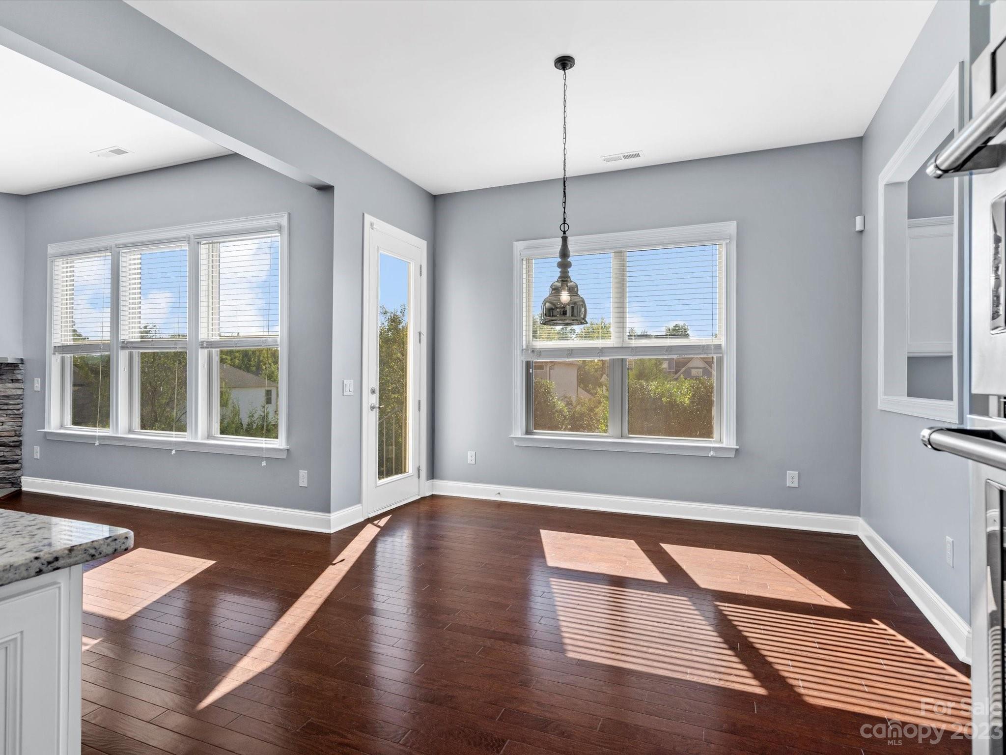 7009 Fallondale Road Waxhaw, NC 28173 - Photo 14 of 47 a view of an empty room with wooden floor and a window