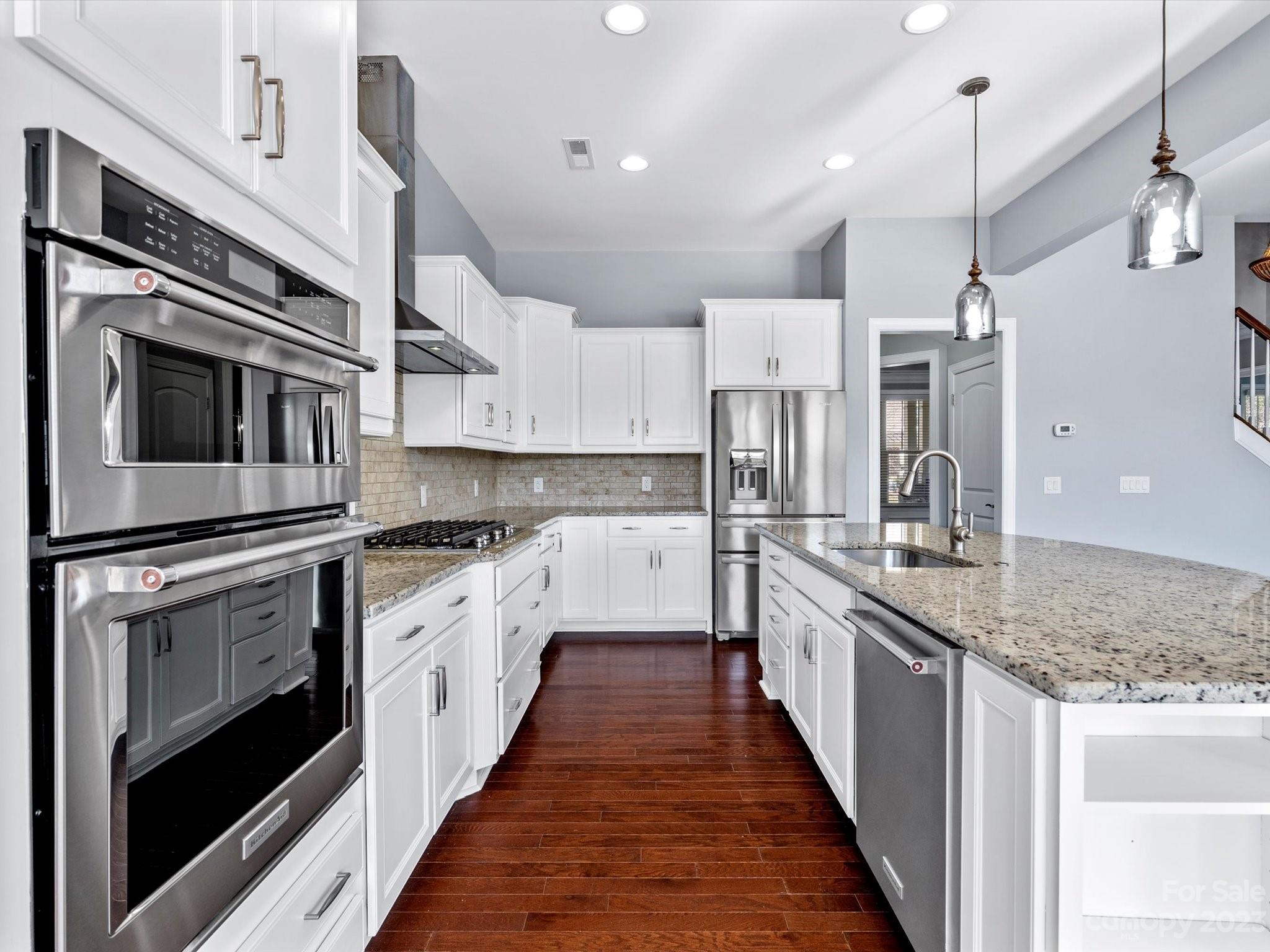 7009 Fallondale Road Waxhaw, NC 28173 - Photo 18 of 47 a kitchen with stainless steel appliances granite countertop lots of counter space a sink and cabinets