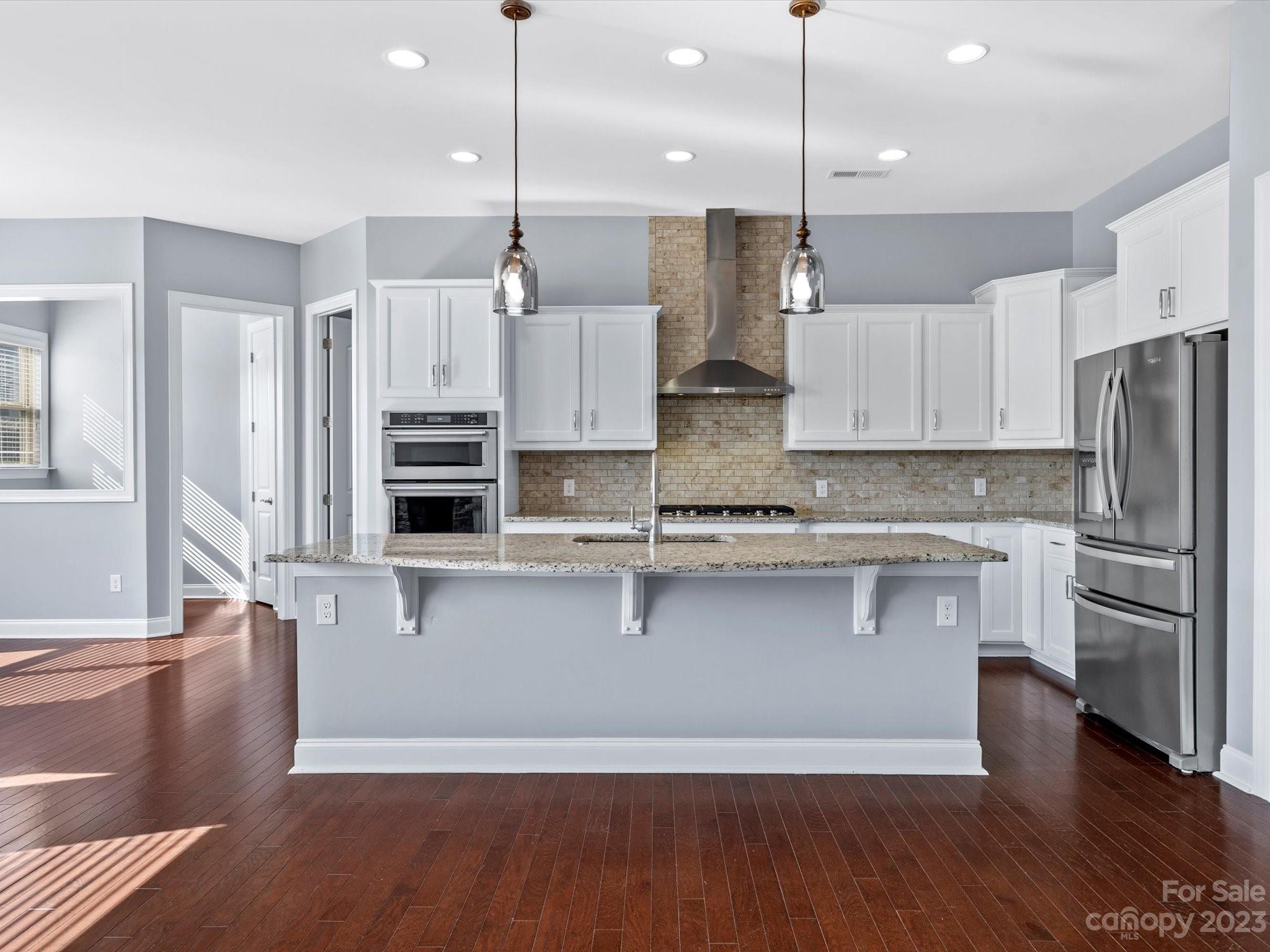 7009 Fallondale Road Waxhaw, NC 28173 - Photo 20 of 47 a kitchen with stainless steel appliances granite countertop a refrigerator a oven and a wooden floors
