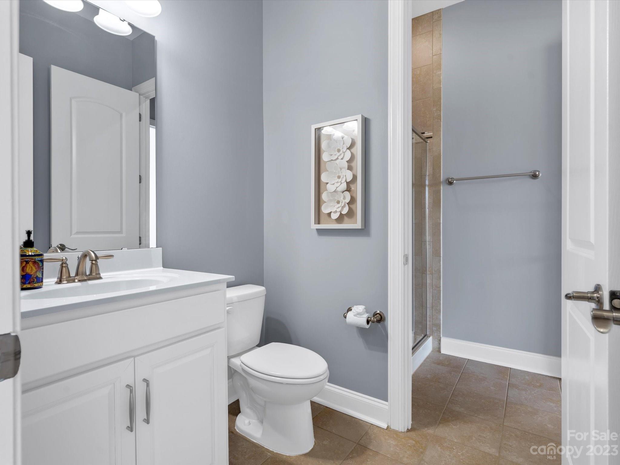 7009 Fallondale Road Waxhaw, NC 28173 - Photo 25 of 47 a bathroom with a toilet sink vanity and mirror