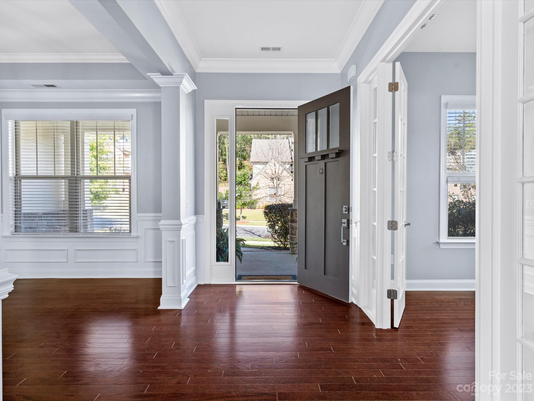 7009 Fallondale Road Waxhaw, NC 28173 - Photo 3 of 47 a view of a hallway with wooden floor and windows