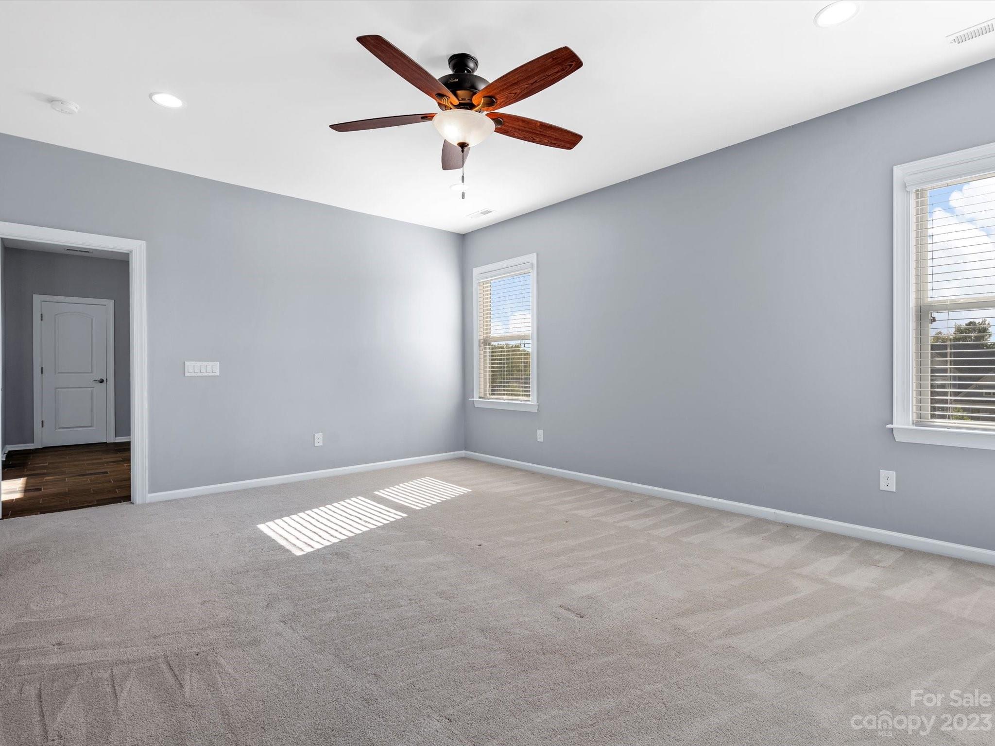 7009 Fallondale Road Waxhaw, NC 28173 - Photo 34 of 47 an empty room with windows and ceiling fan