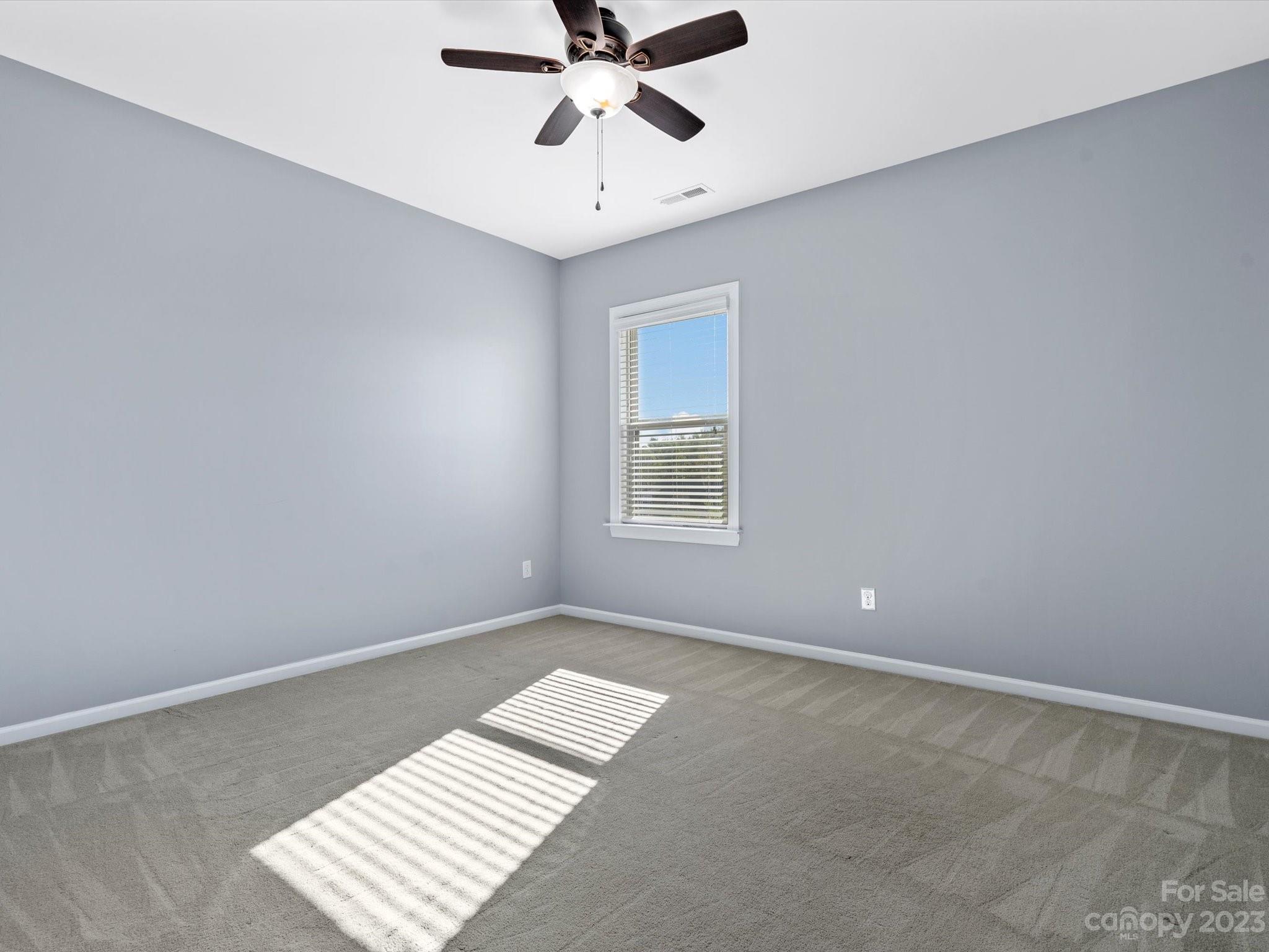 7009 Fallondale Road Waxhaw, NC 28173 - Photo 39 of 47 an empty room with ceiling fan and window