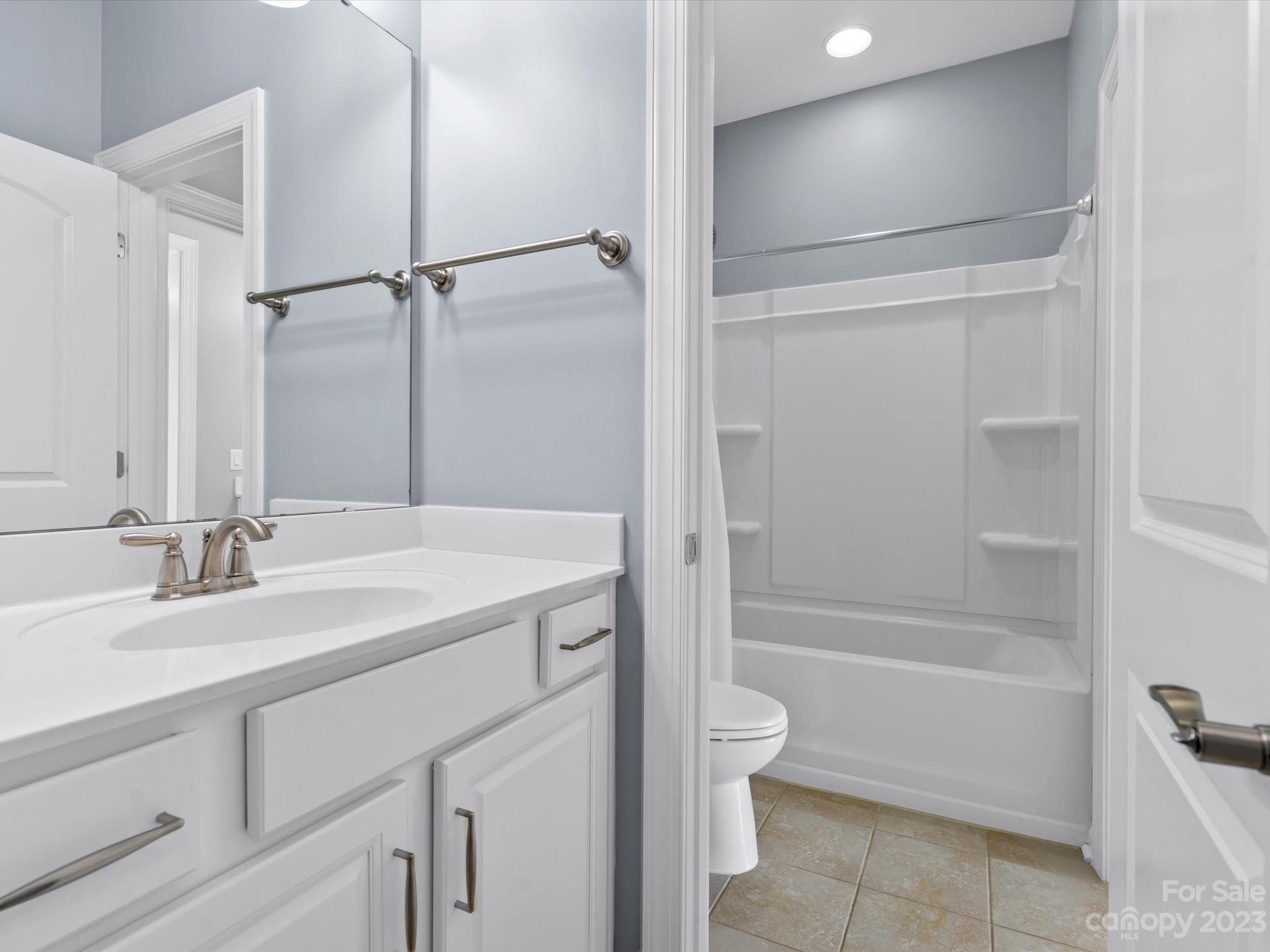 7009 Fallondale Road Waxhaw, NC 28173 - Photo 41 of 47 a bathroom with a tub sink vanity granite and toilet