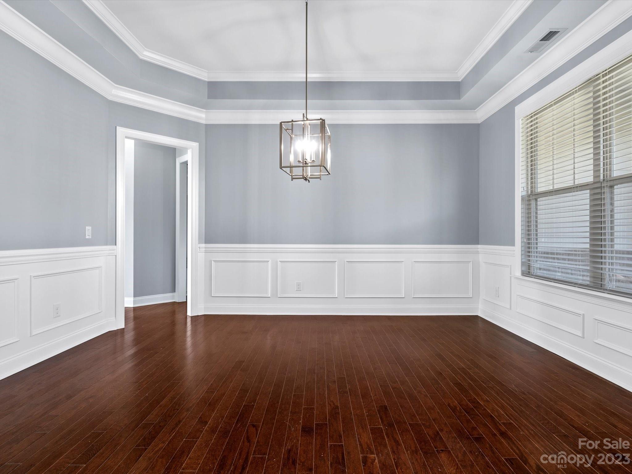 7009 Fallondale Road Waxhaw, NC 28173 - Photo 5 of 47 a view of an empty room with wooden floor and a window