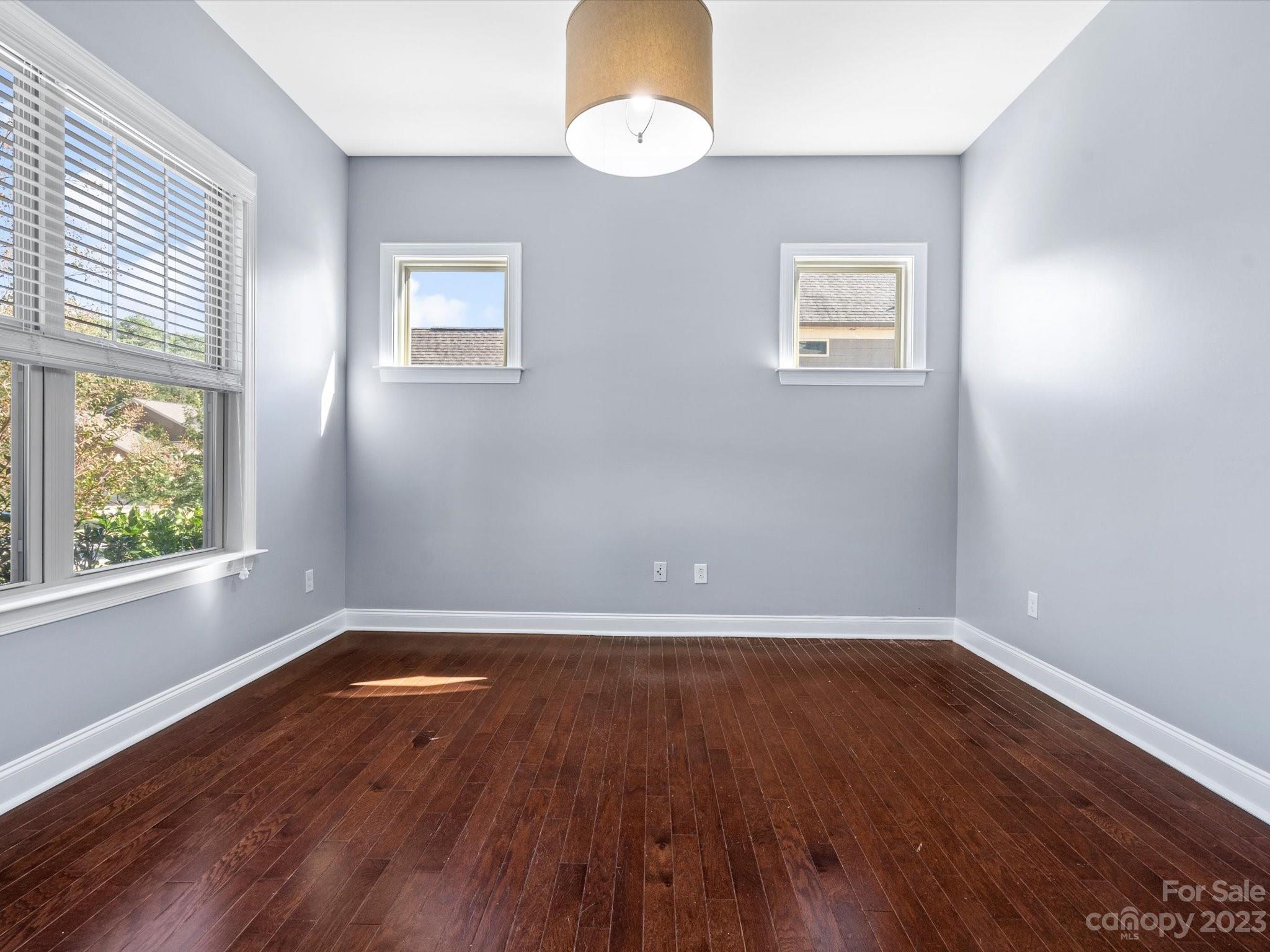 7009 Fallondale Road Waxhaw, NC 28173 - Photo 7 of 47 an empty room with wooden floor and windows