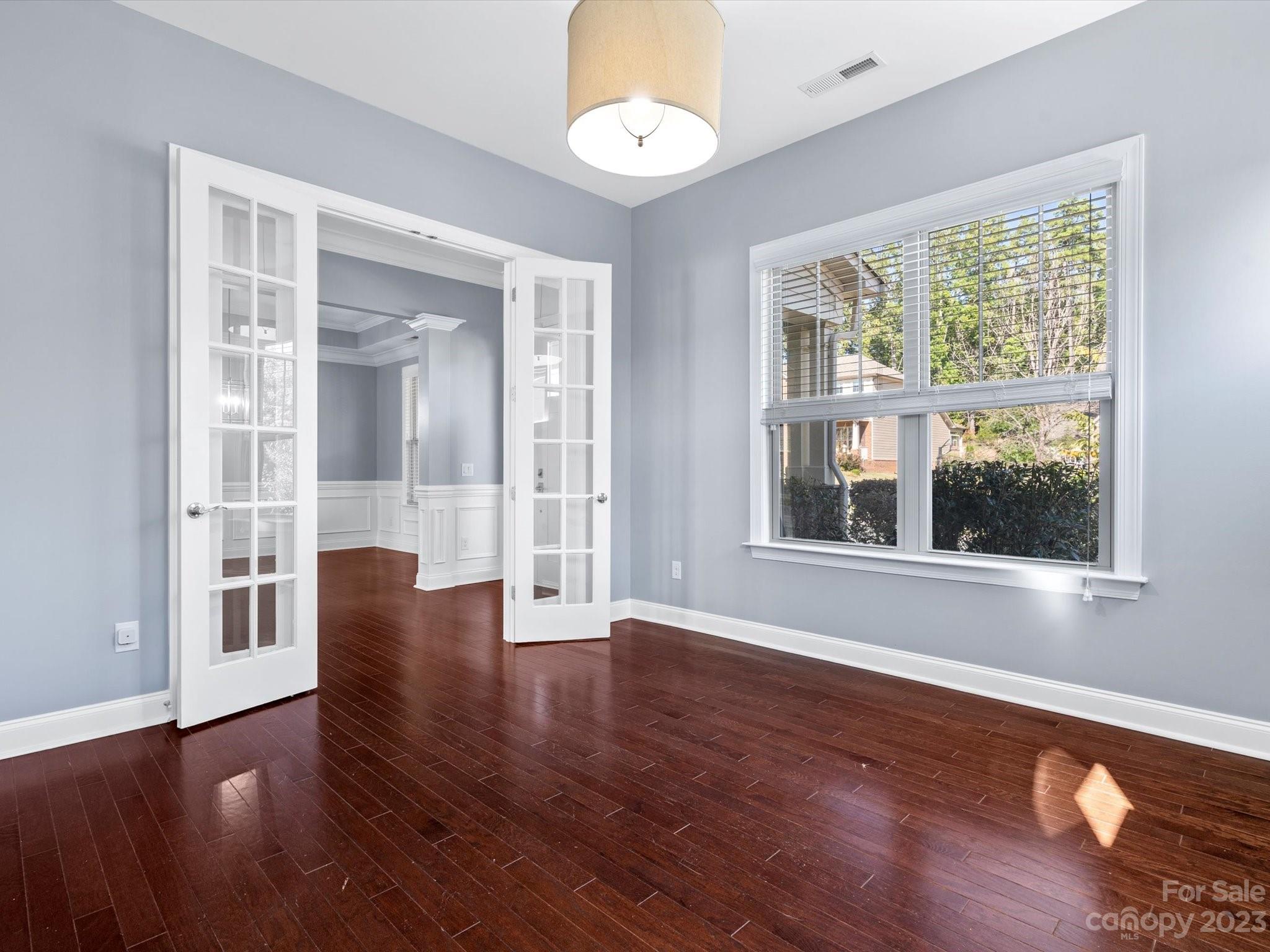 7009 Fallondale Road Waxhaw, NC 28173 - Photo 8 of 47 a view of an empty room with wooden floor and a window