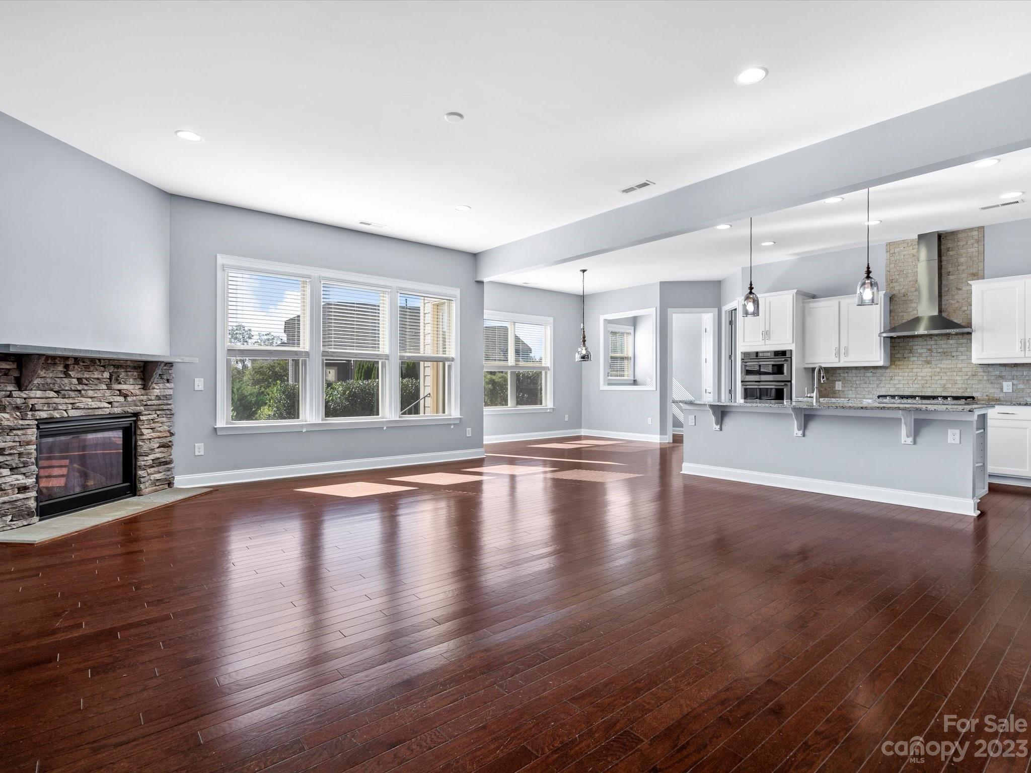 7009 Fallondale Road Waxhaw, NC 28173 - Photo 10 of 47 a view of empty room with wooden floor and fireplace