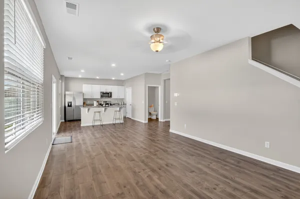 a view of kitchen with furniture and wooden floor