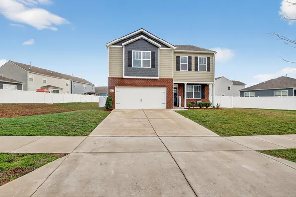 a front view of a house with a yard and garage