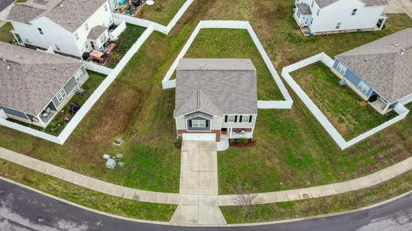 an aerial view of a house with a swimming pool
