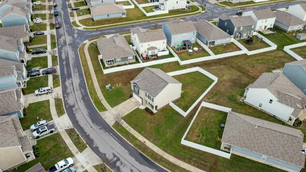 an aerial view of house with a yard