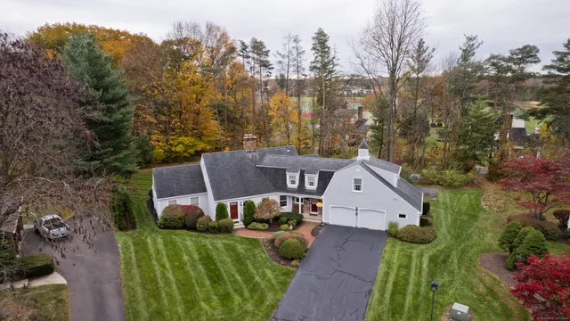 an aerial view of a house with a big yard