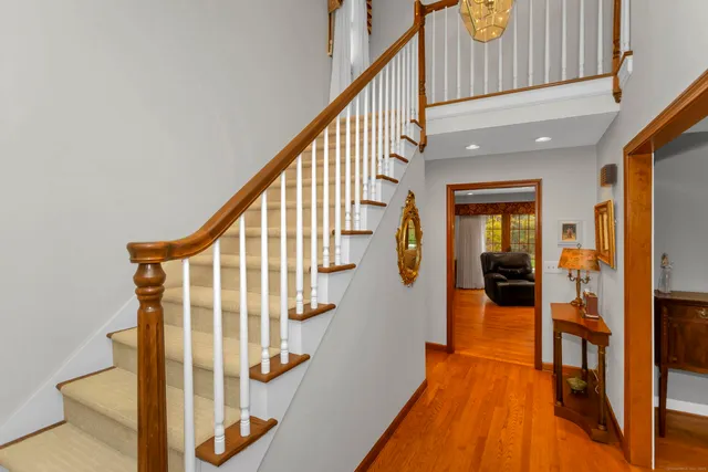 a view of entryway and hall with wooden floor