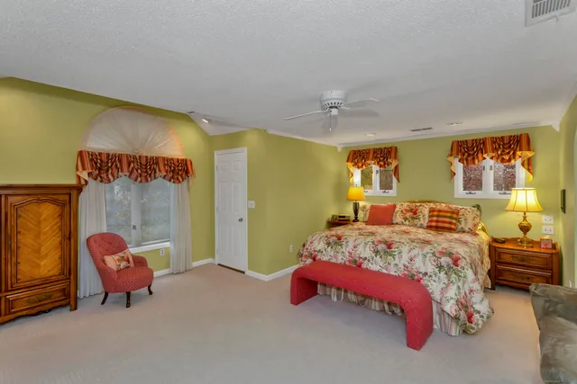 a bed room with a bed and a chair