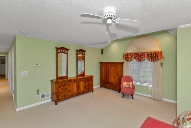 a bed room with furniture and a window