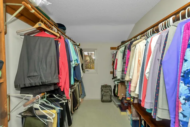 a view of walk in closet with clothes