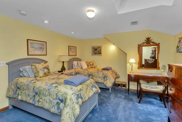 a spacious bedroom with a bed and a table in it