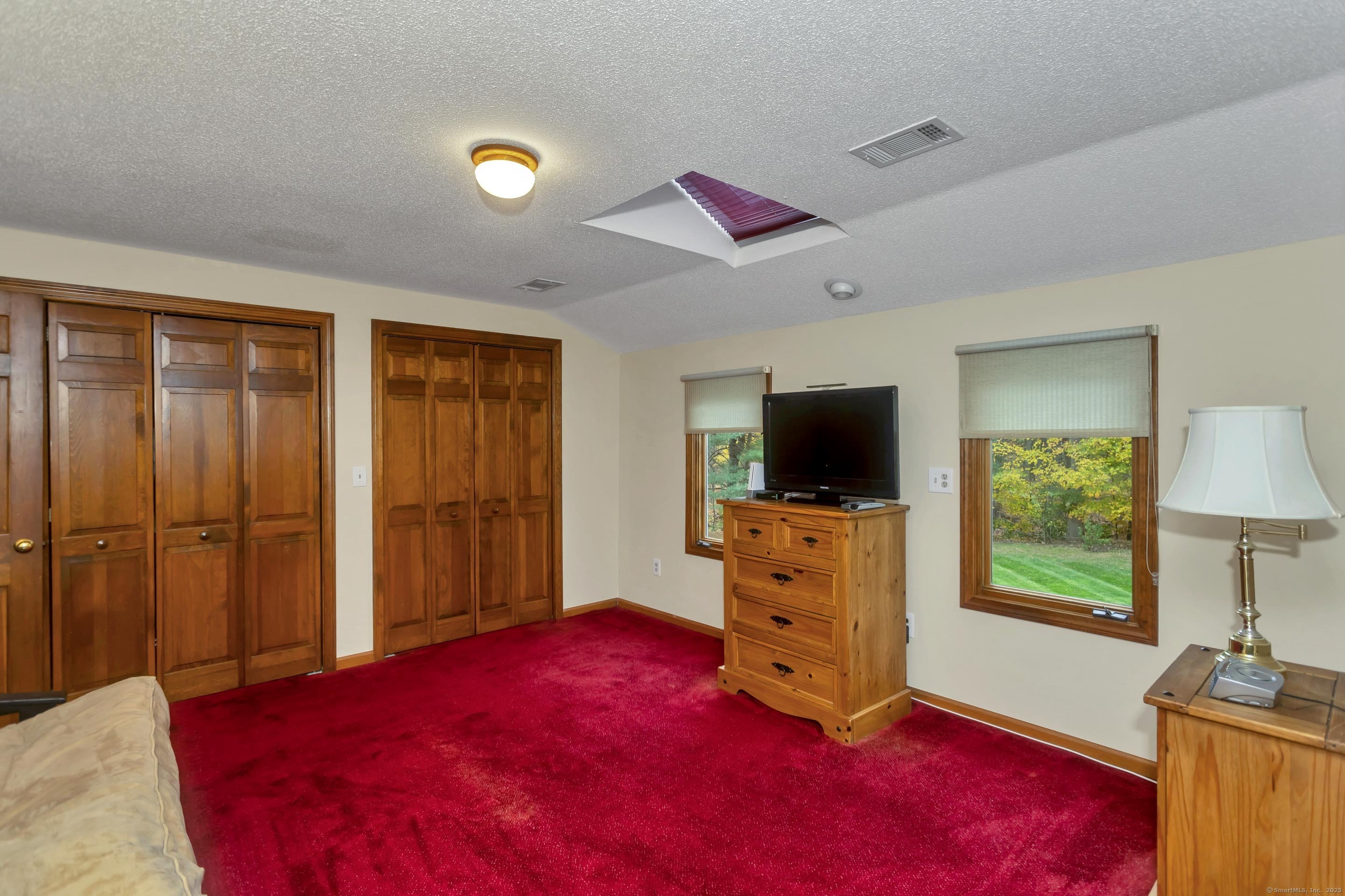 41 Huckleberry Hollow Suffield, CT 06078 - Photo 33 of 40 a bedroom with a bed and a flat screen tv