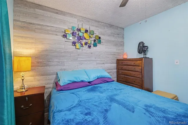 a bedroom with a bed and ceiling fan