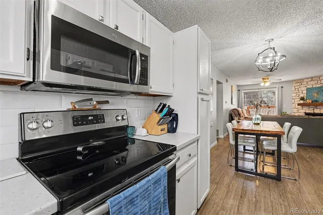 a kitchen with stainless steel appliances a stove microwave and cabinets