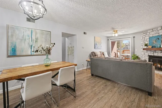 a dining room with furniture a window and wooden floor