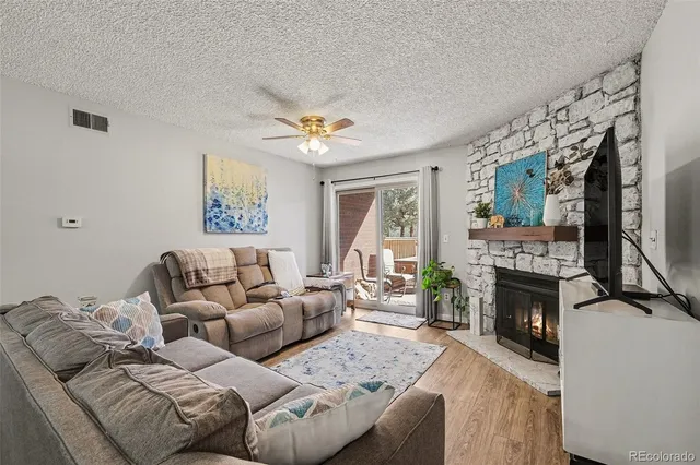 a living room with furniture a fireplace and a window