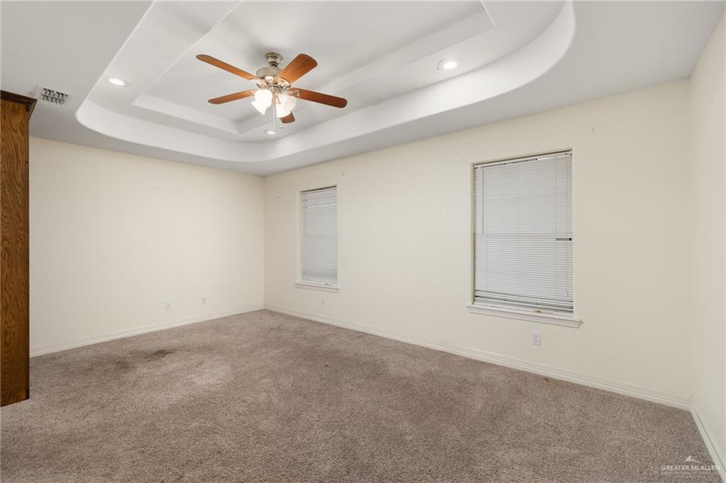 417 Jessica Street Mercedes, TX 78570 - Photo 6 of 12 an empty room with ceiling fan and windows